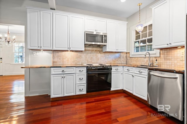 kitchen with white cabinets, stainless steel appliances, and dark wood-type flooring