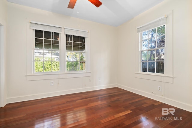 spare room featuring ceiling fan and dark wood-type flooring