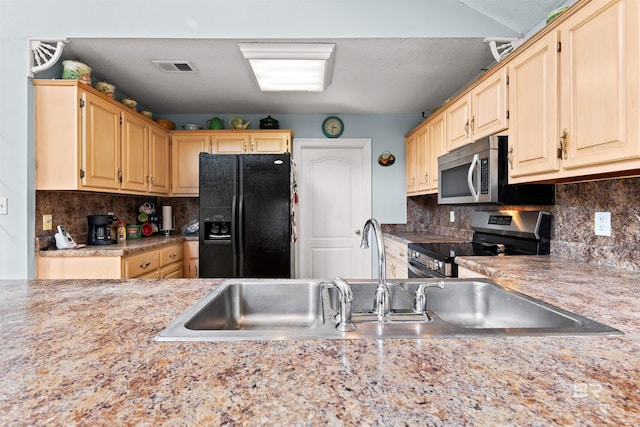 kitchen featuring visible vents, a sink, light countertops, appliances with stainless steel finishes, and backsplash