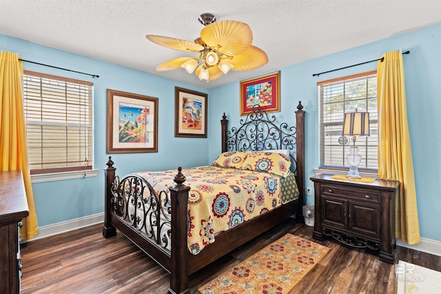 bedroom with ceiling fan, a textured ceiling, baseboards, and wood finished floors