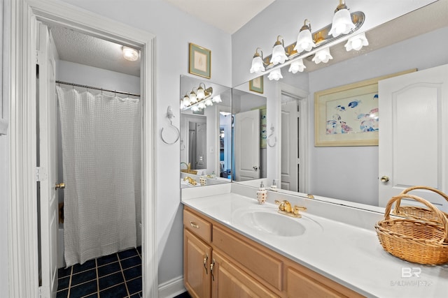 bathroom with tile patterned floors, a shower with curtain, a textured ceiling, and vanity