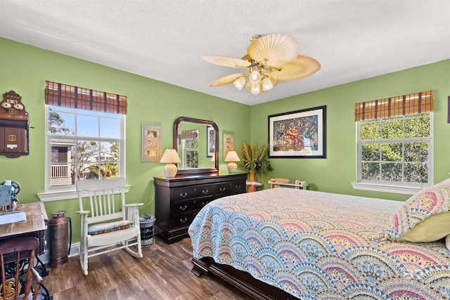 bedroom with a ceiling fan, wood finished floors, and a textured ceiling