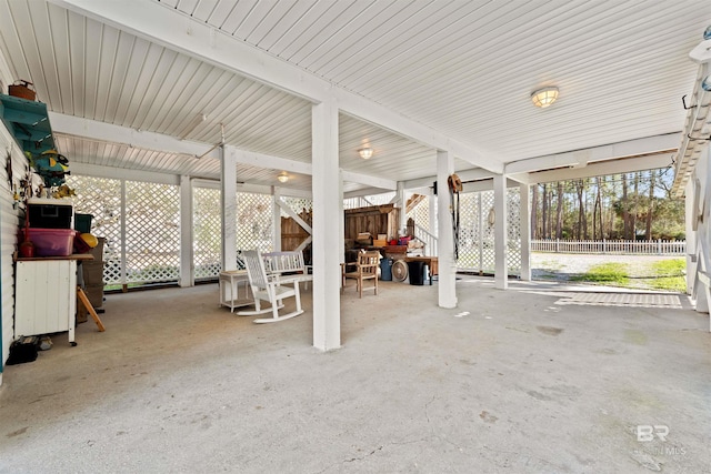 view of patio / terrace with a carport and fence