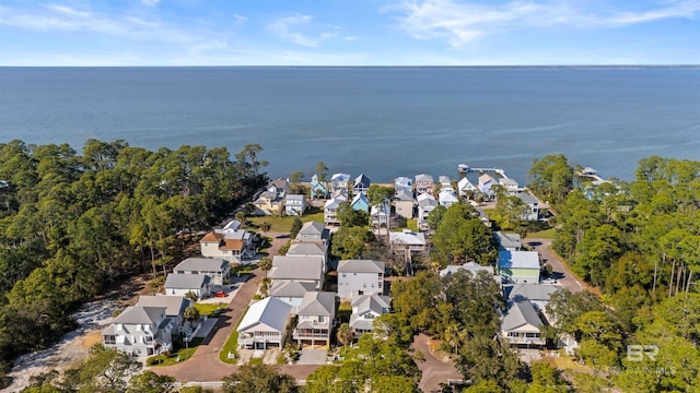 drone / aerial view with a residential view and a water view