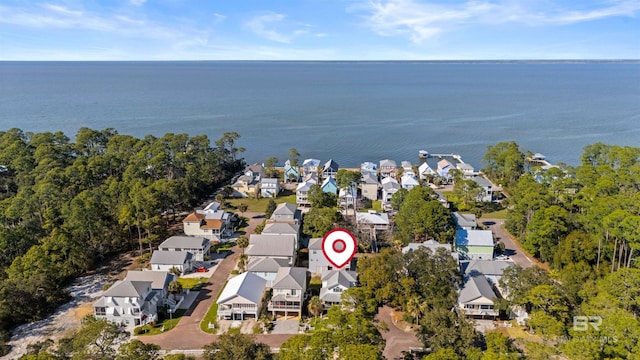 drone / aerial view featuring a residential view and a water view