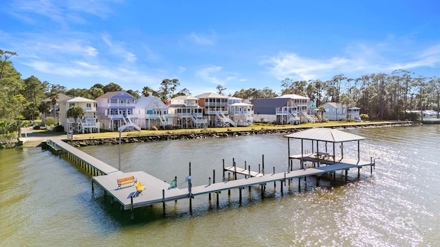 dock area featuring a residential view, boat lift, and a water view