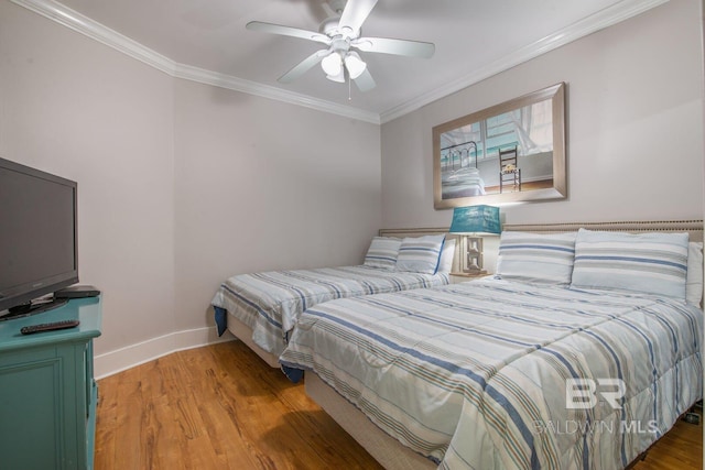 bedroom featuring ornamental molding, ceiling fan, and light wood-type flooring