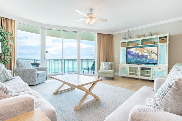 tiled living room featuring a wall of windows, a water view, ceiling fan, and crown molding