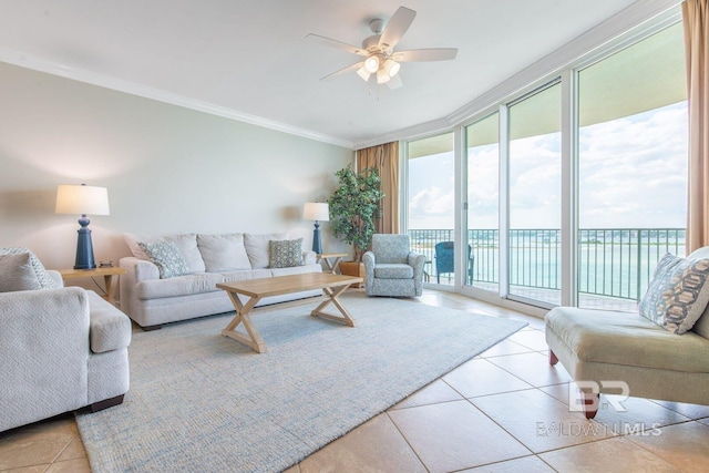 tiled living room with ceiling fan, a water view, ornamental molding, and a wall of windows