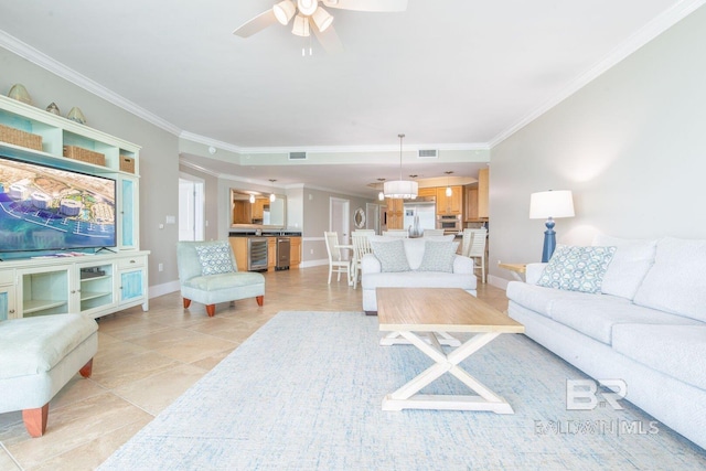 living room with ceiling fan, ornamental molding, and light tile floors