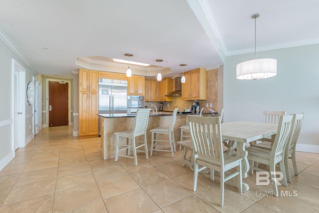 tiled dining area featuring crown molding