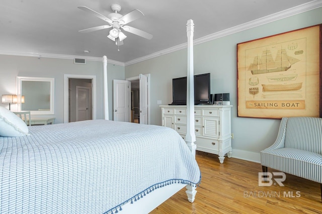 bedroom with crown molding, ceiling fan, and light hardwood / wood-style floors