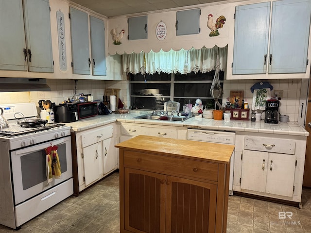 kitchen with tasteful backsplash, white appliances, a sink, and under cabinet range hood