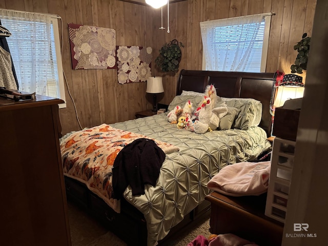 bedroom with wood walls