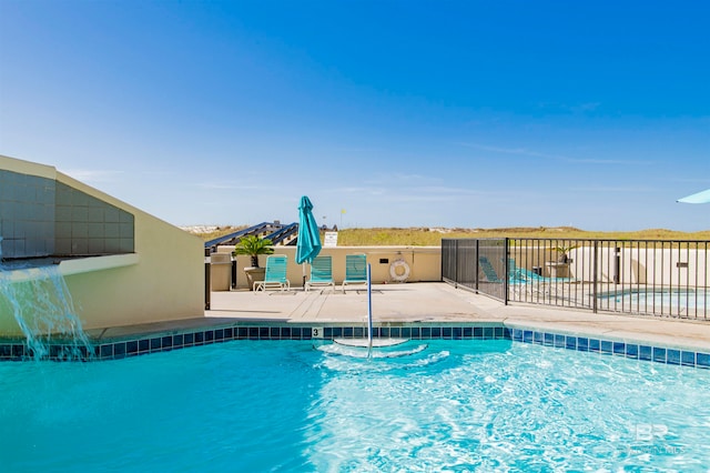 view of swimming pool with a patio