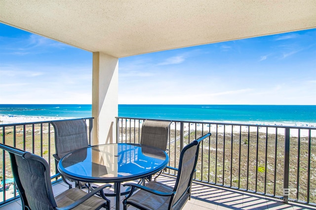 balcony with a view of the beach and a water view