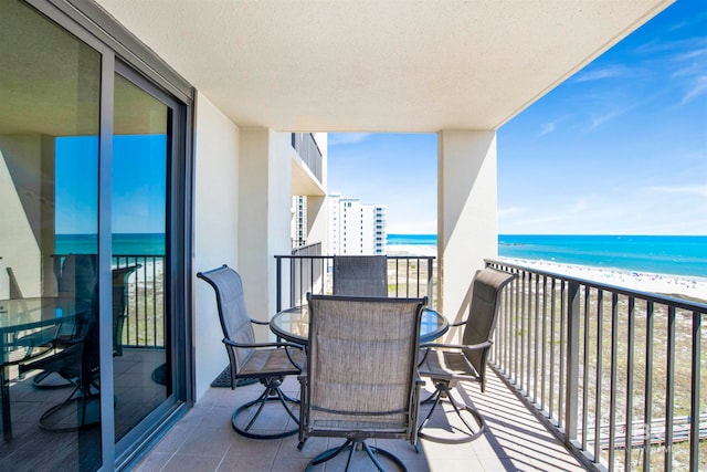 balcony with a water view and a beach view