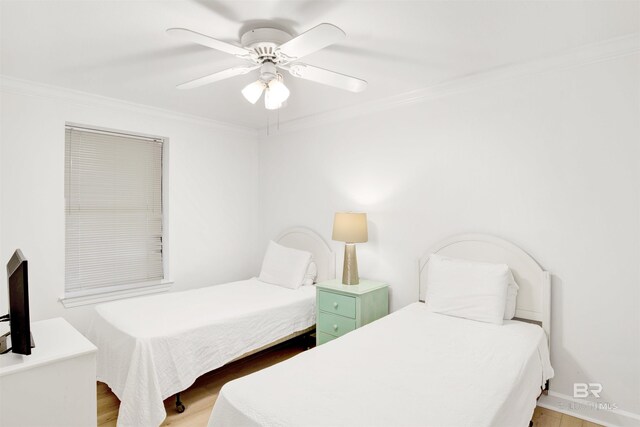 bedroom with ceiling fan, light hardwood / wood-style floors, and ornamental molding