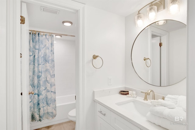 full bathroom with shower / bath combination with curtain, toilet, and vanity