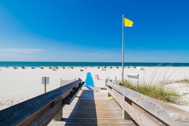 dock area featuring a beach view and a water view