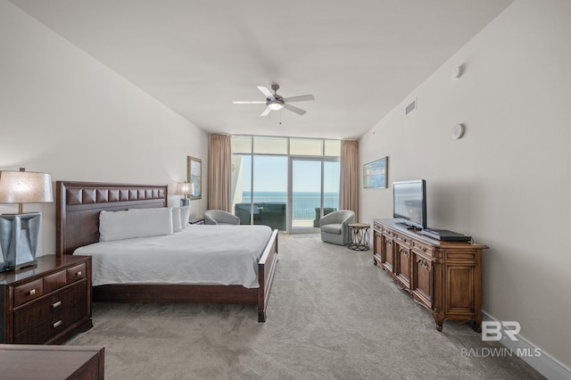 carpeted bedroom featuring access to exterior, visible vents, a ceiling fan, a wall of windows, and baseboards