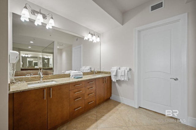 bathroom with tile patterned flooring, visible vents, a sink, and double vanity