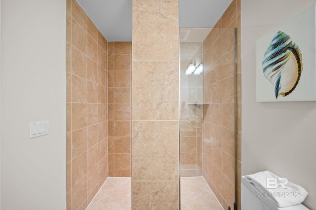 bathroom featuring toilet and a tile shower