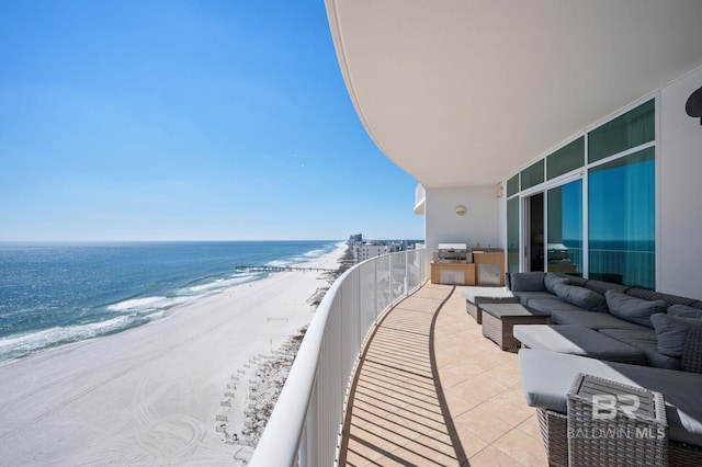 balcony featuring a beach view, a grill, an outdoor living space, and a water view