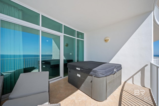 view of patio / terrace featuring a balcony and a hot tub