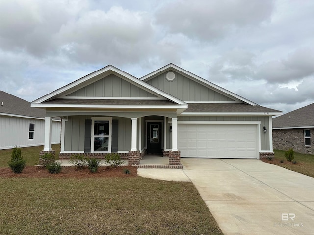 craftsman inspired home featuring a front yard, covered porch, and a garage