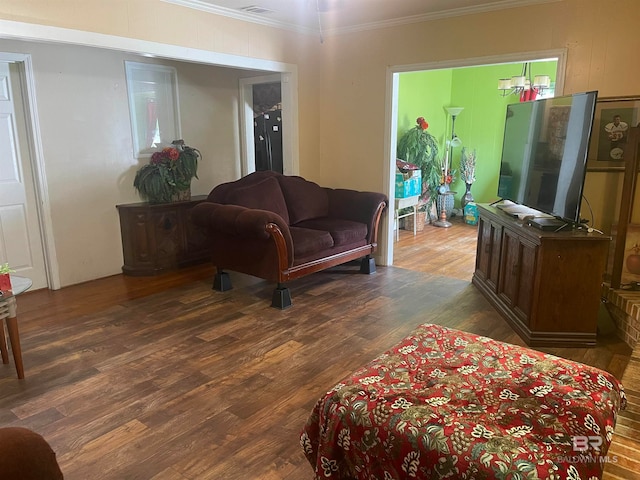 living room with dark hardwood / wood-style flooring and ornamental molding