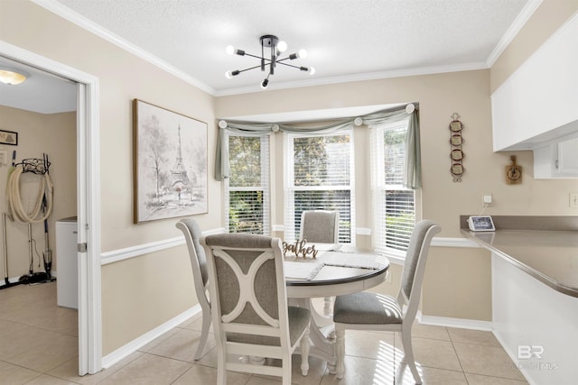 7431 Summer Ct, Mobile, AL 36695 - dining room featuring light tile patterned floors, a textured ceiling, ornamental molding, a chandelier, and baseboards