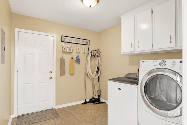 7431 Summer Ct, Mobile, AL 36695 - washroom featuring cabinet space, separate washer and dryer, baseboards, light tile patterned flooring, and a textured ceiling