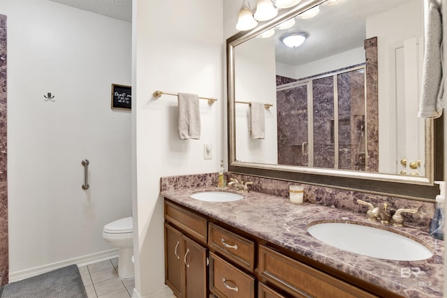 7431 Summer Ct, Mobile, AL 36695 - bathroom featuring a shower stall, tile patterned flooring, toilet, double vanity, and a textured ceiling