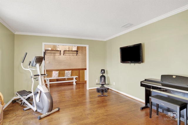 7431 Summer Ct, Mobile, AL 36695 - workout room featuring crown molding, wood finished floors, and baseboards