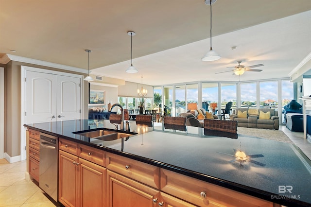 kitchen with brown cabinets, a sink, dark countertops, open floor plan, and light tile patterned floors