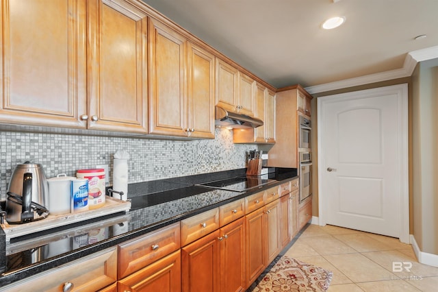 kitchen featuring crown molding, under cabinet range hood, decorative backsplash, light tile patterned flooring, and black electric cooktop