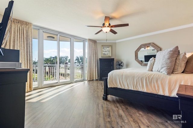 bedroom with access to exterior, ceiling fan, a wall of windows, ornamental molding, and wood finished floors