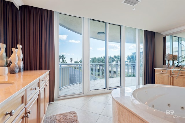 full bathroom featuring vanity, a tub with jets, visible vents, expansive windows, and tile patterned floors