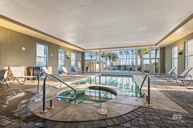 pool with a lanai, a patio, and an indoor hot tub