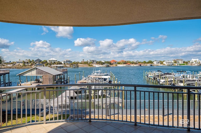 balcony featuring a water view, boat lift, and a dock