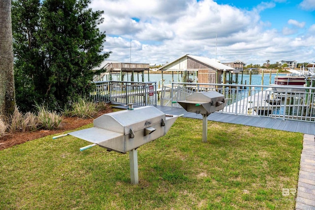 view of dock featuring a yard, a water view, and boat lift