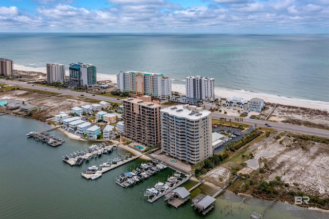 birds eye view of property with a view of city and a water view