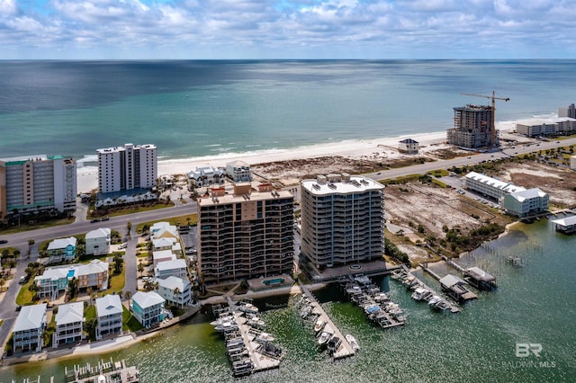 drone / aerial view featuring a city view and a water view