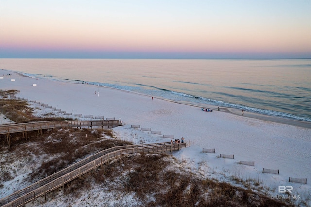 aerial view with a water view and a beach view