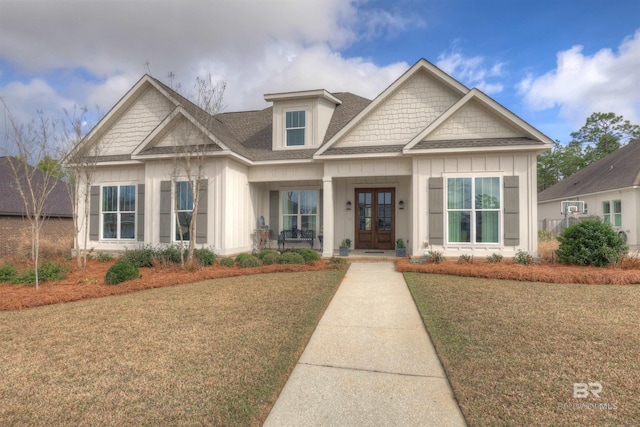 craftsman inspired home with a front lawn and french doors