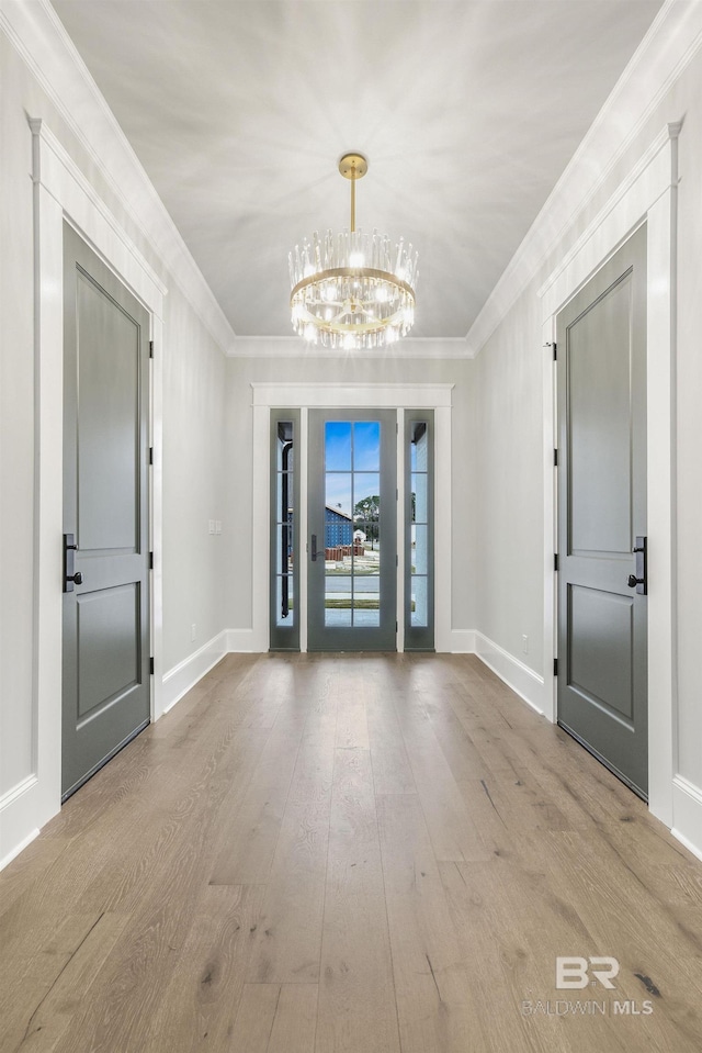 845 Inlet Cir, Gulf Shores, AL 36542 - entrance foyer featuring a chandelier, hardwood / wood-style flooring, and crown molding