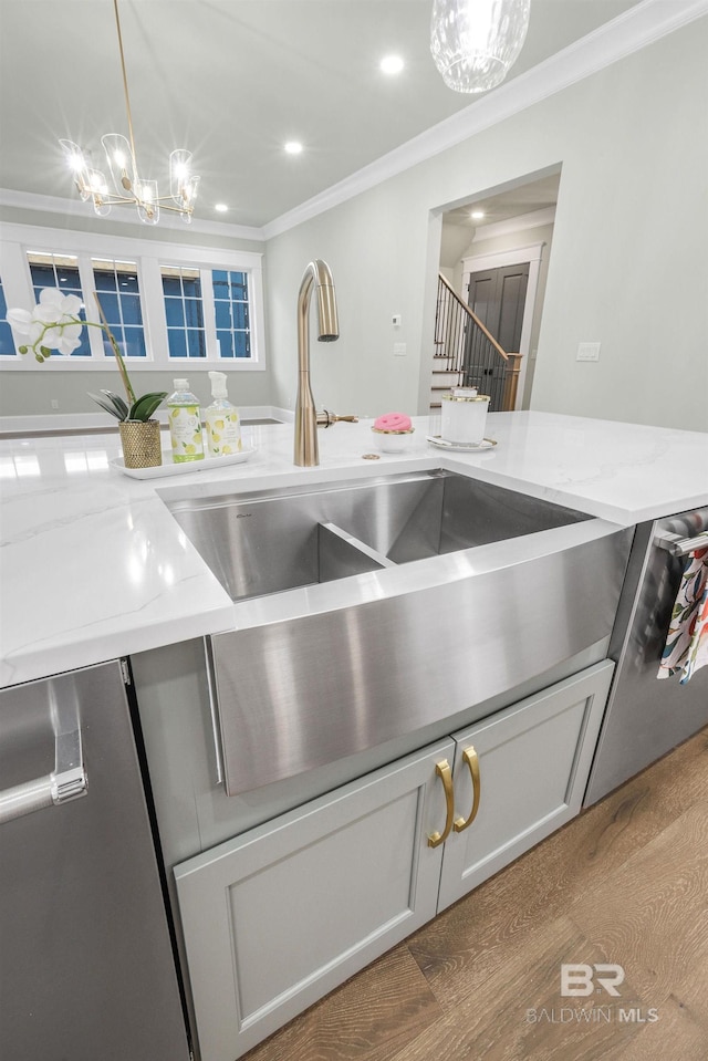 845 Inlet Cir, Gulf Shores, AL 36542 - kitchen view of a chandelier, ornamental molding, hanging light fixtures, light stone countertops, and recessed lighting