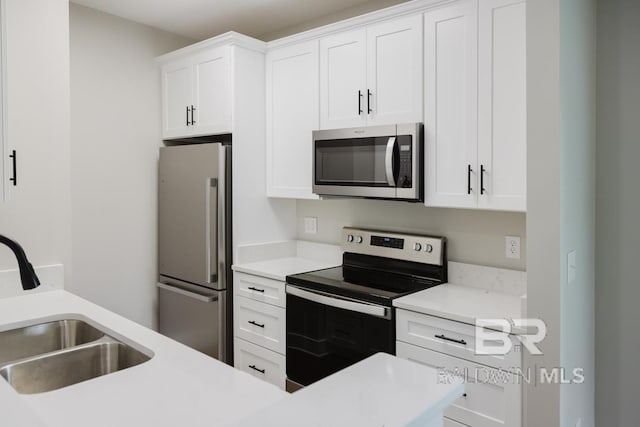 kitchen with white cabinetry, appliances with stainless steel finishes, and sink