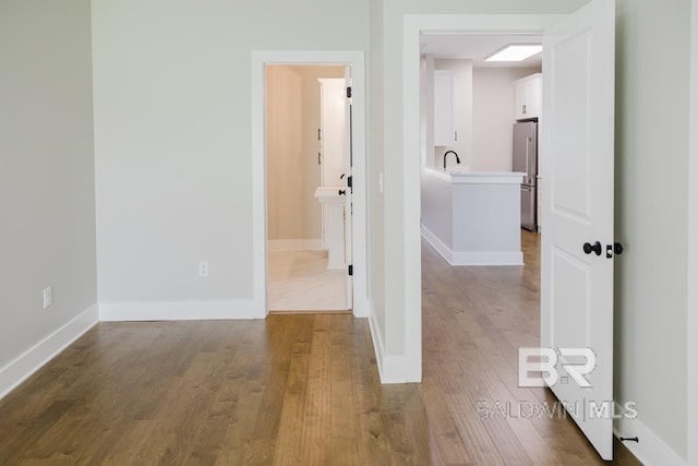 corridor with wood-type flooring